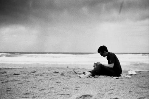 Cole reads a book on the beach